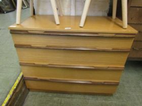 A mid-20th century teak chest of four drawers