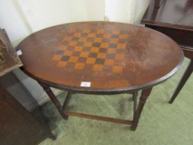 An Edwardian mahogany oval games table