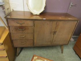 A mid-20th century veneered sideboard having four drawers and a pair of cupboard doors on splayed