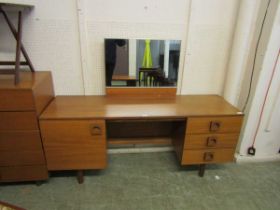 A mid-20th century teak dressing table with mirror to back