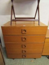 A mid-20th century teak chest of five drawers