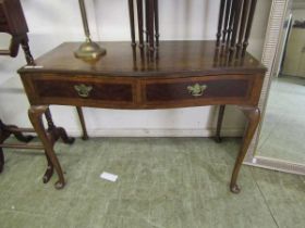 A mid-20th century walnut veneered serpentine hall table with two drawers on cabriole supports