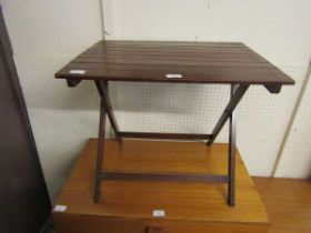 A stained wooden folding occasional table