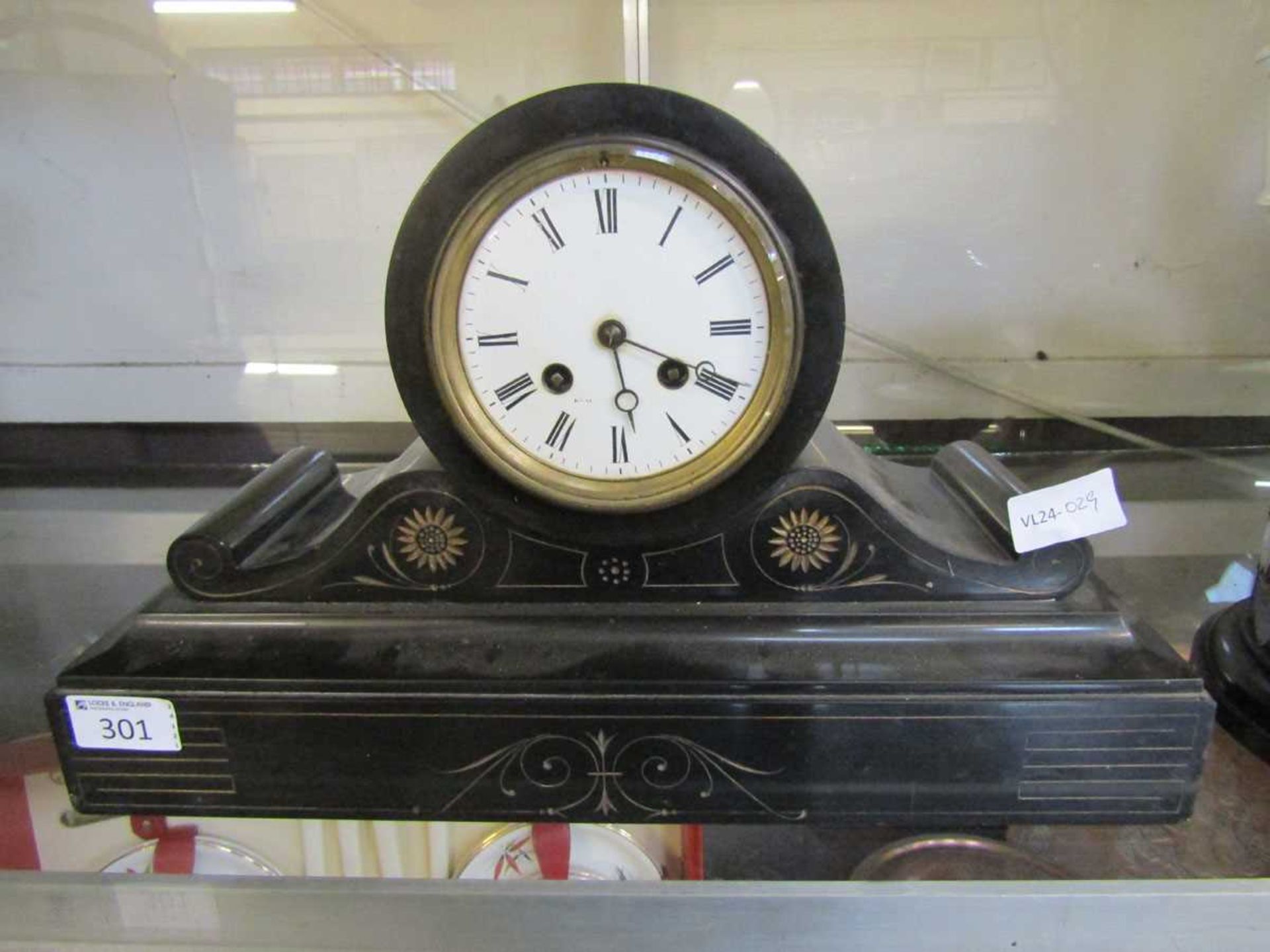 A Victorian black slate mantel clock