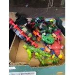 A carton containing a selection of 'Master's Of The Universe' figures and toys to include He-Man,