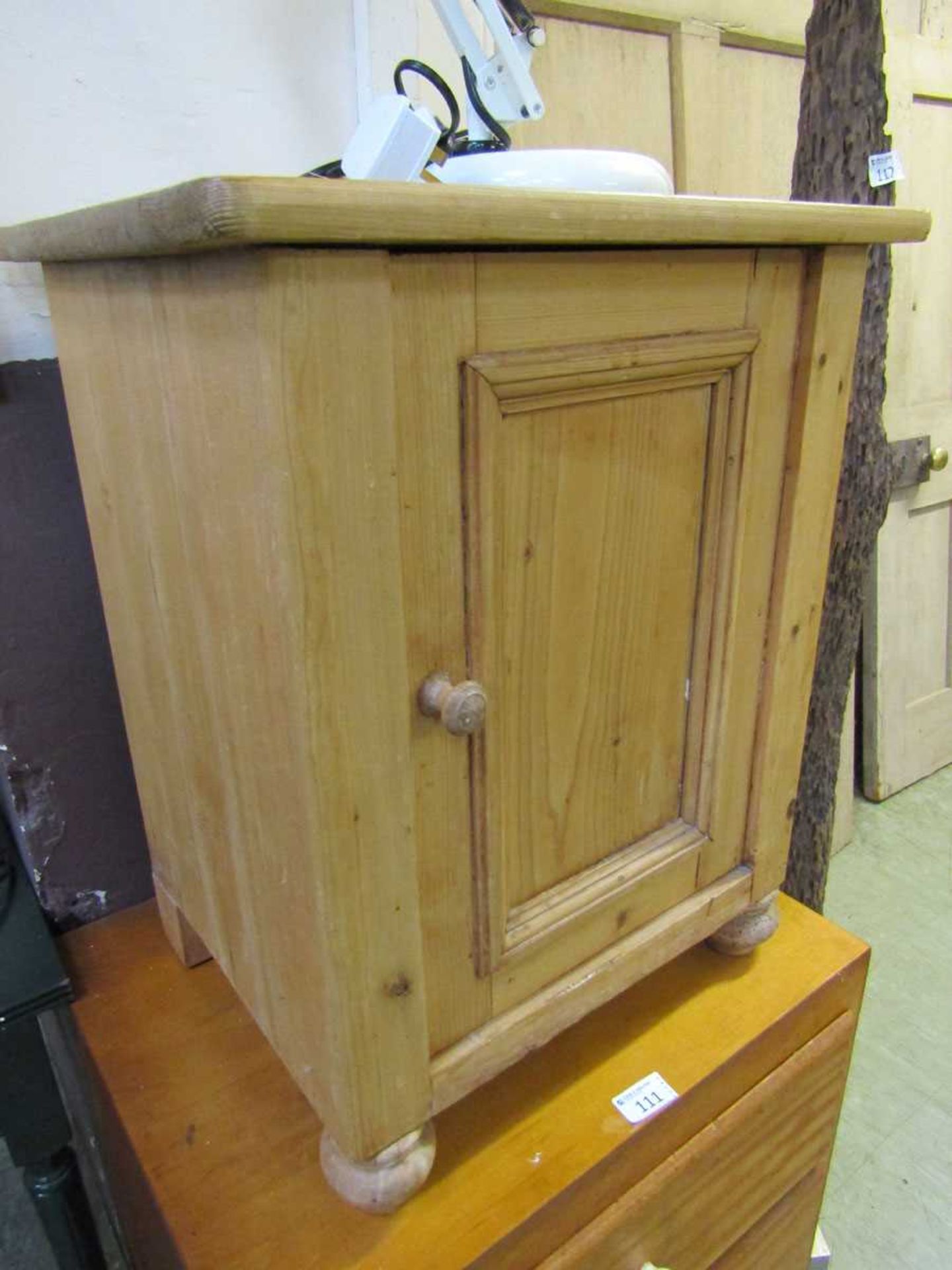 A waxed pine cabinet with single door