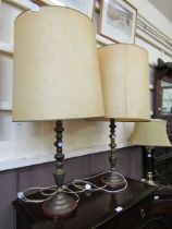 A pair of brass columned table lamps