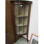 An early 20th century Sheraton revival mahogany inlaid bow front glazed display cabinet on splayed