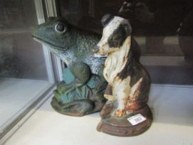 Two cast metal doorstops in the form of a frog and a dog