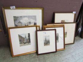 A collection of seven framed and glazed coloured etchings of buildings