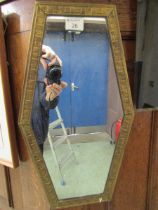 A mid-20th century embossed brass framed wall mirror