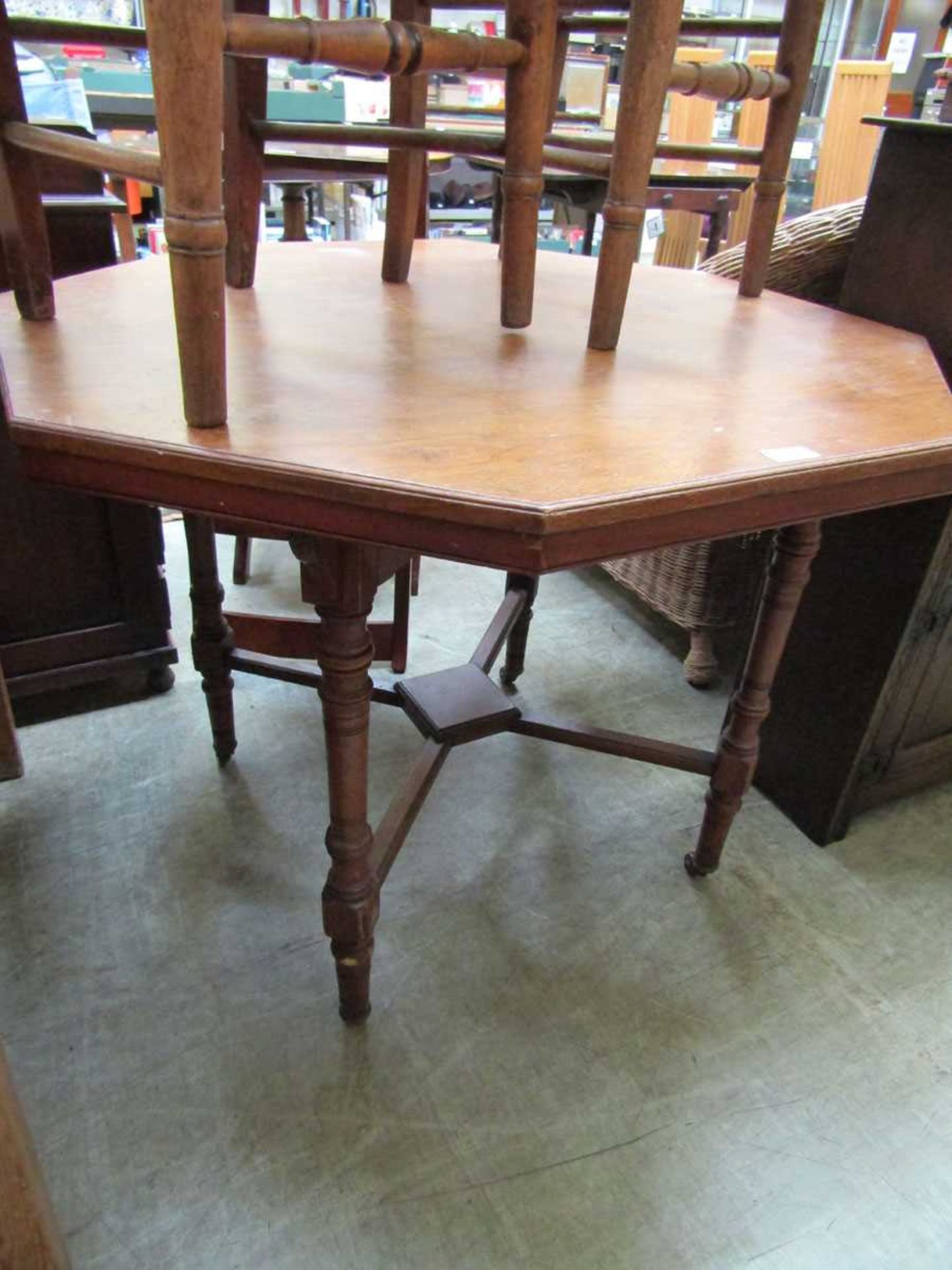 An Edwardian oak octagonal table on turned supports