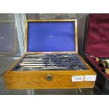 A boxed set of draughtsmen's tools