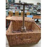 An old wash dolly together with a wicker basket