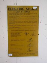 A painted metal sign explaining how to respond to an electric shock 51cm x 31cm