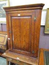 A reproduction George III style oak wall mounted corner cupboard, 72cm wide