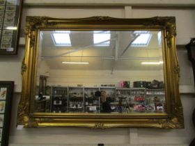 A modern gilt framed mirror with rectangular bevel glass, 90cm x 64.5cm