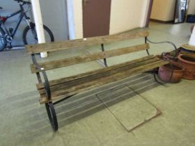 A late 19th century garden bench with wooden slats and metal ends, 180.5cm long