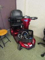 An Invacare mobility scooter with charger and keys