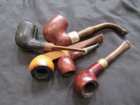 A bag containing five assorted pipes