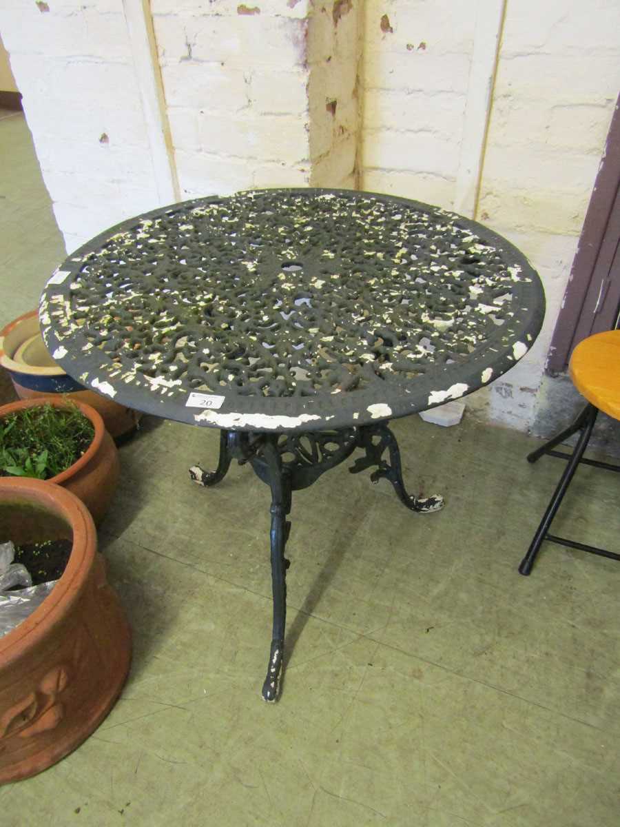A cast metal circular garden table, diameter 74cm