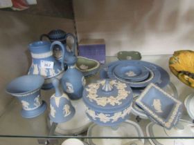 A large assortment of Wedgwood Jasperware items to include lidded pots, water jugs, bell, etc
