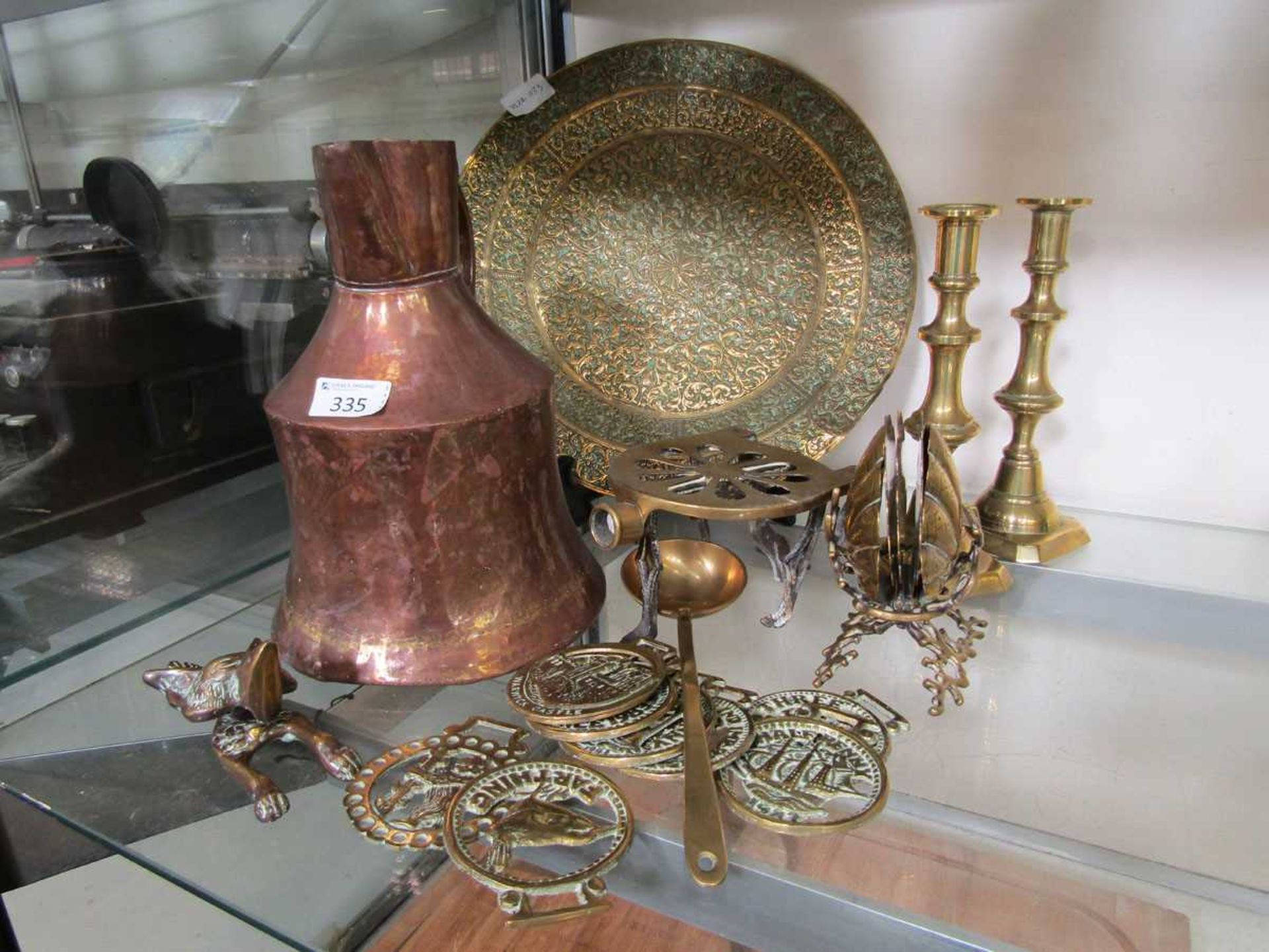 A selection of brass and copper ware to include water jug, candlesticks, embossed tray, horse