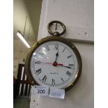 A modern brass cased quartz wall clock