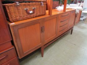 A mid-20th century G-Plan teak sideboard having four centre drawers flanked by two pairs of cupboard