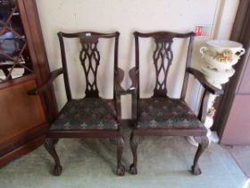 A pair of early 20th century Chippendale style mahogany armchairs