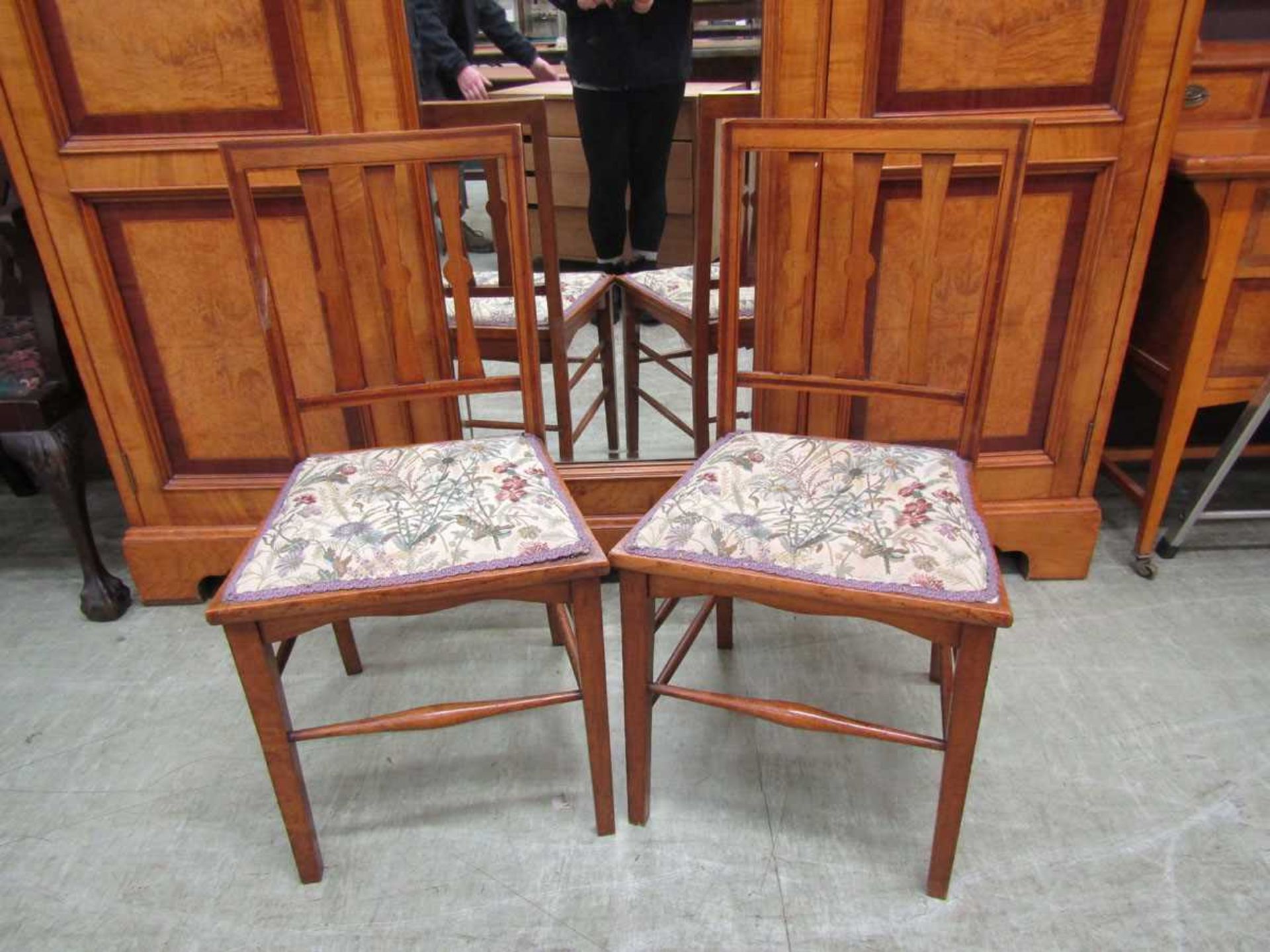 A pair of oak and satinwood chairs One chair has a missing spindle and the back is loose. Second