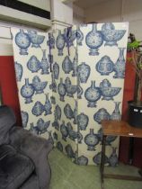 A fabric upholstered three fold screen with Chinese urn design