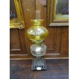 A Victorian brass and cast metal oil lamp