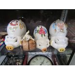 Five assorted ceramic comical money boxes in the form of pigs