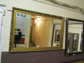 A reproduction ornate gilt framed bevel glass wall mirror