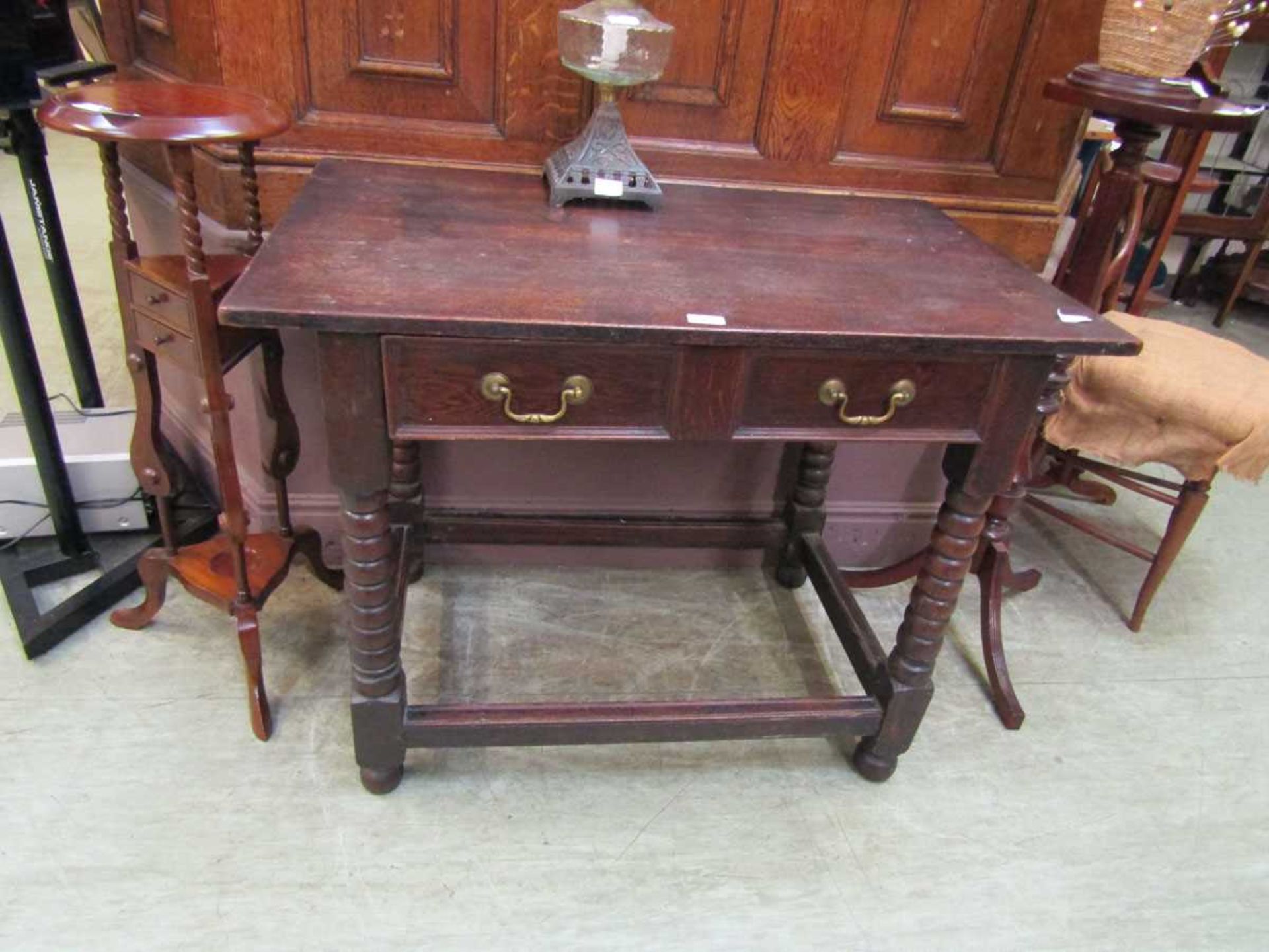 A 19th century style oak hall table having one drawer on turned supports