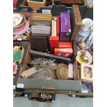 A tray containing cased flatware, glassware, etc