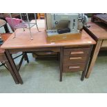 A mid-20th century teak desk having pedestal of three drawers