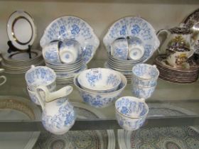 An assortment of blue and white Granger tableware to include cake plates, cups, saucers, bowls, etc