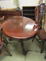 A Victorian style mahogany tilt top pedestal table with carved base