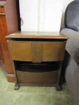 A mid-20th century oak sewing box with lift up lid