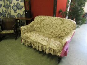 An Edwardian mahogany framed settee with a loose bird design covering