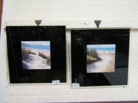 Two prints of dune scenes on black glass backings