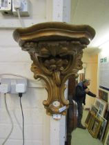 An ornate gilt painted plaster wall mounted shelf