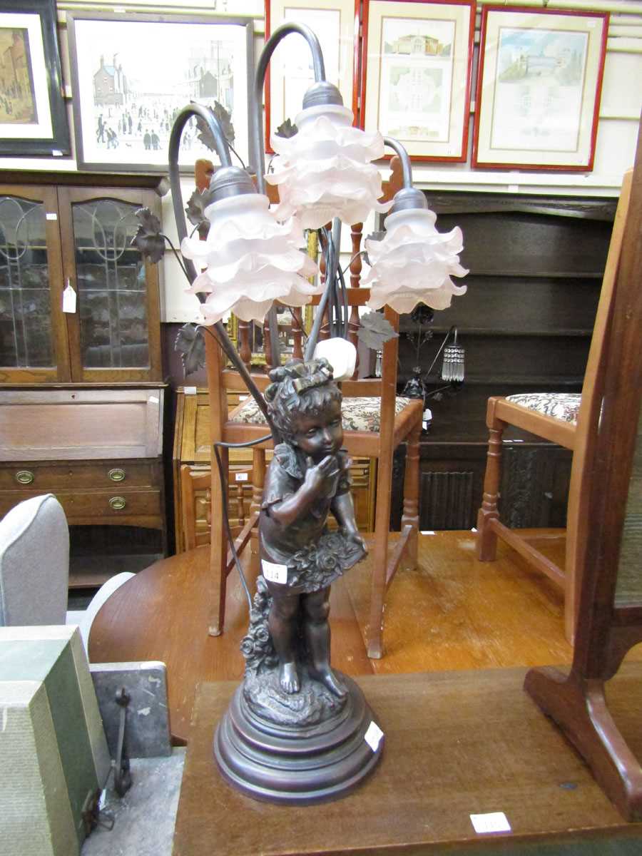 A moulded table lamp with three pink shades with young girl design