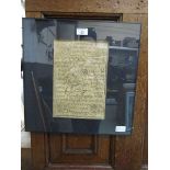 A black framed and glazed Tibetan prayer.