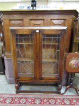 A mid-20th century carved oak leaded glazed two door bookcase