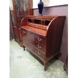 A reproduction continental cylinder bureau with three drawers