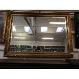 A gilt framed rectangular bevel glass wall mirror