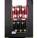 A cased set of silver hallmarked bean spoons together with a case containing six silver hallmarked